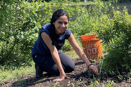 Volunteer working on a project next to the lake