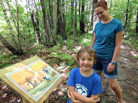 parent and child learning about nature in the woods