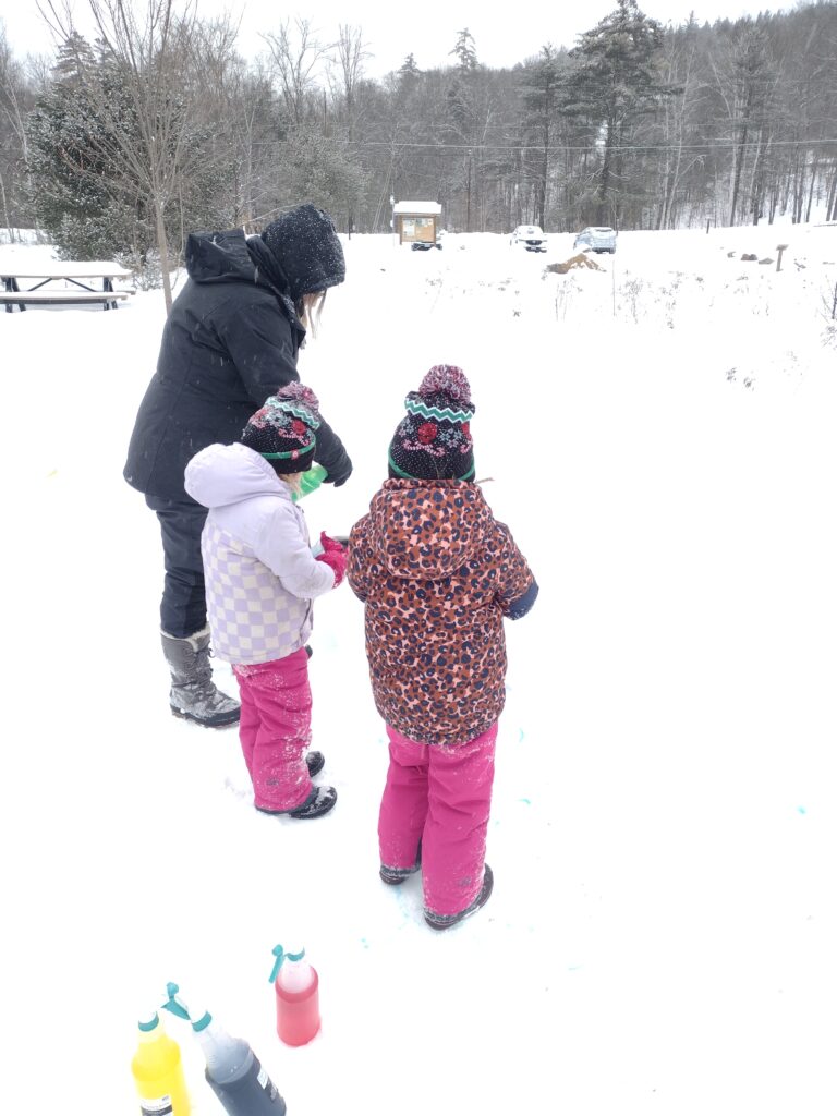 trio playing in snow